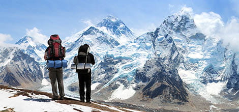 Two explorers looking at Everest